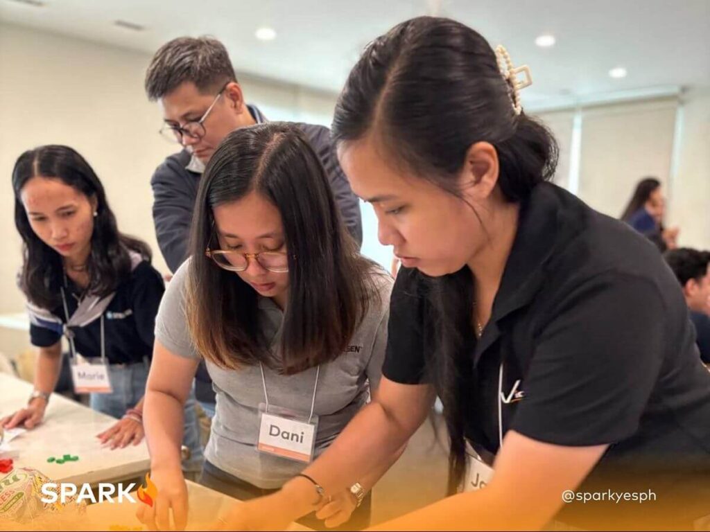 Spark PH team-building participants working together on a hands-on group challenge that encourages collaboration and inclusive participation