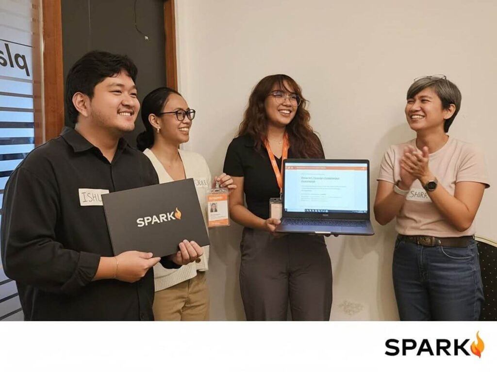 Spark PH team members presenting laptops during a collaborative professional development session focused on AI readiness and digital skills
