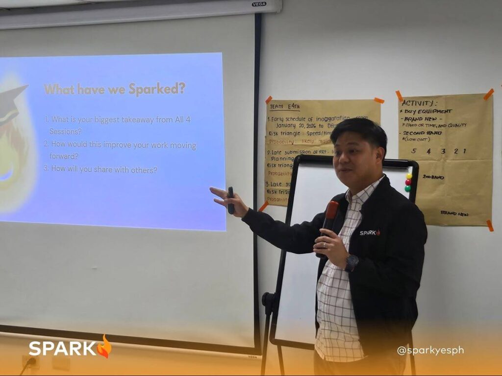 Spark PH facilitator leading a guided reflection session to help employees apply team-building lessons to workplace challenges